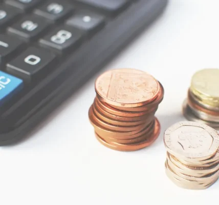 Calculator beside stacks of coins