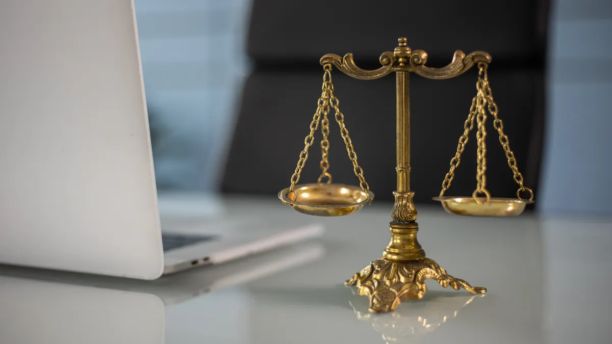desktop laptop with scales figurine