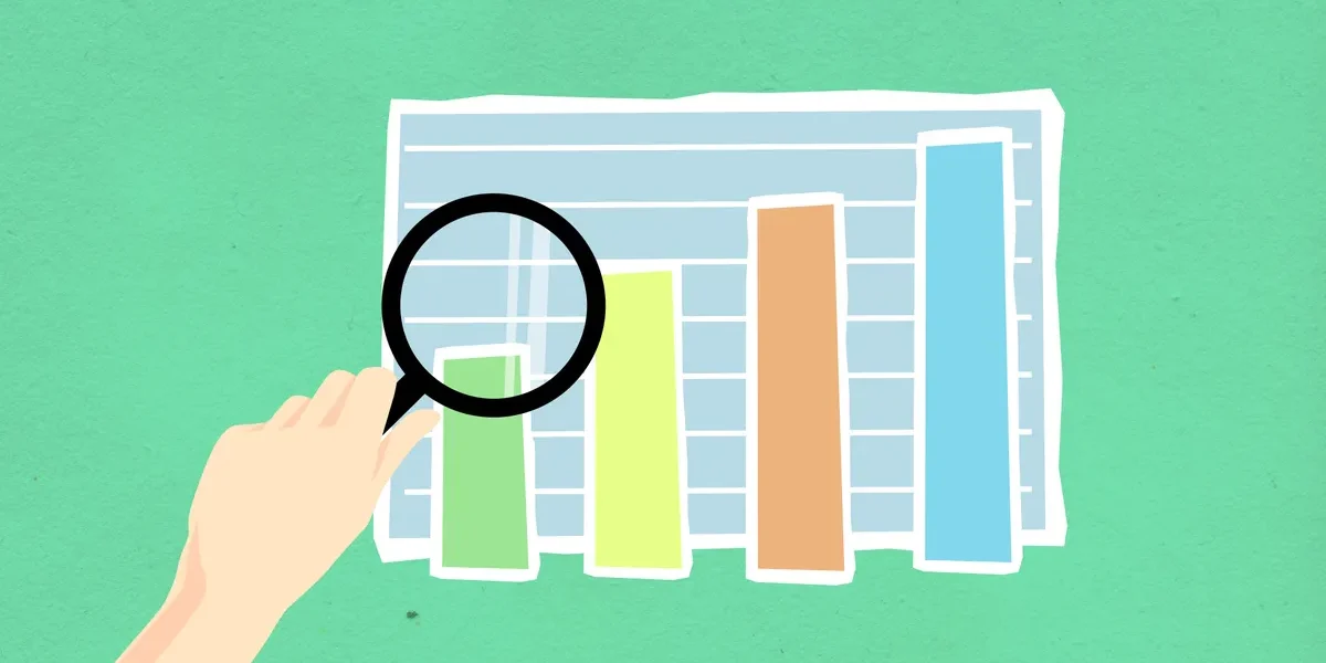 Magnifying glass over bar chart graphic