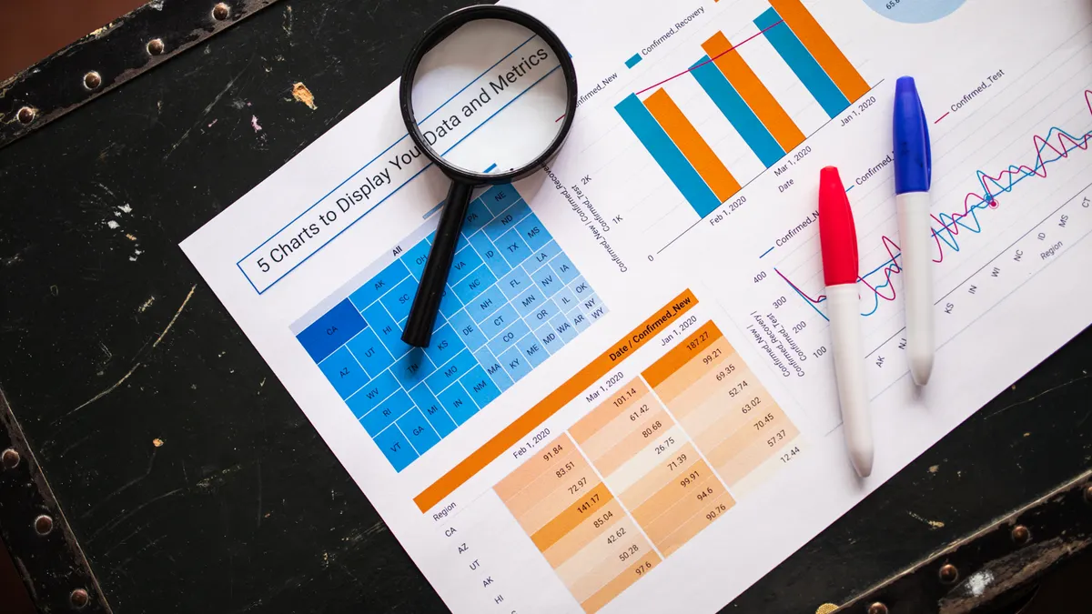 magnifying glass over printed charts and tables