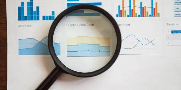 magnifying glass over chart graphics on a report