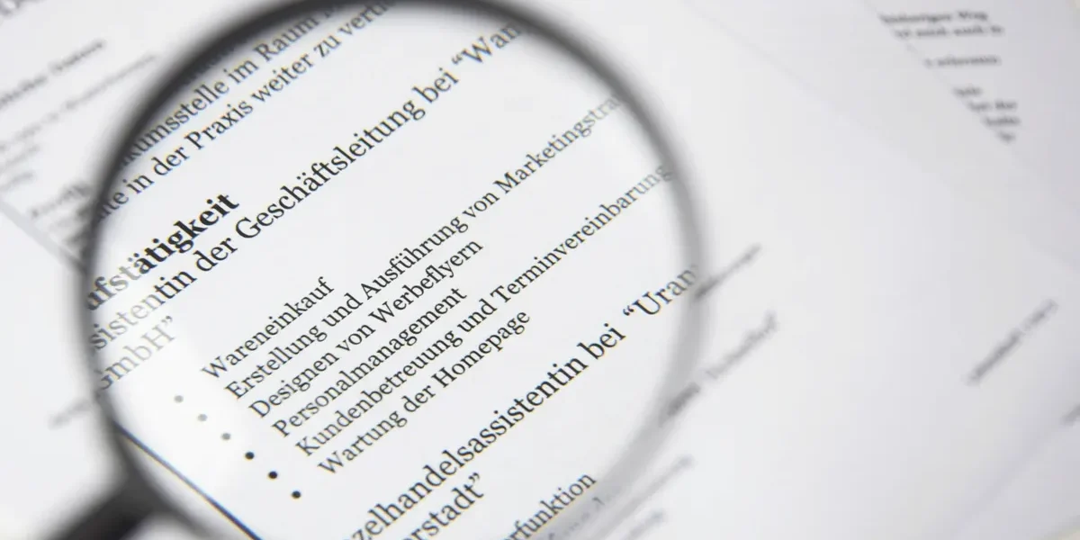 magnifying glass over a text document with bullet points